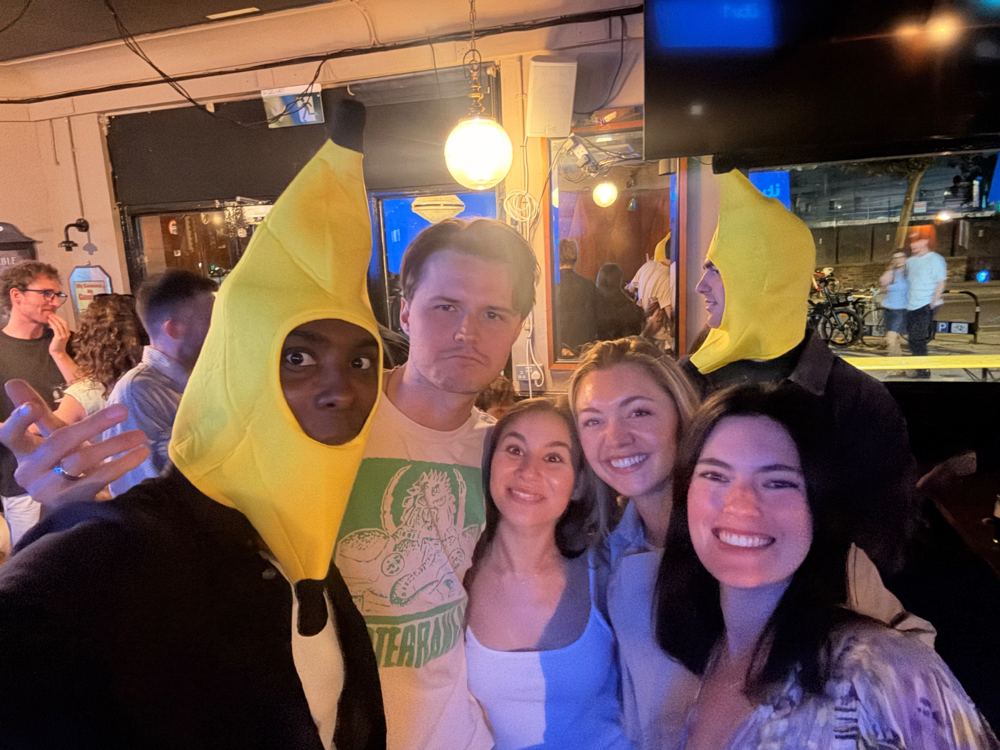A crew in banana hats pulling faces in a pub